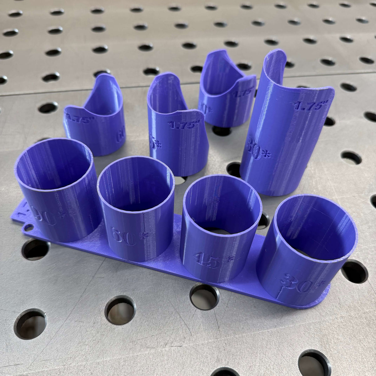 Single size tube notching templates in blue and purple angled